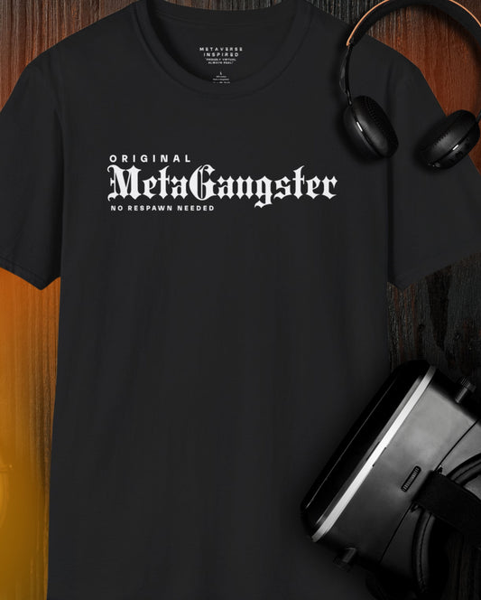 black t-shirt with meta gangster white text on a wood background and a vr headset and headphones nearby