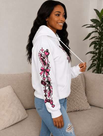 A woman wearing a white hoodie with a large pink and black graphic print on the sleeve, paired with light blue jeans, standing in a living room setting.